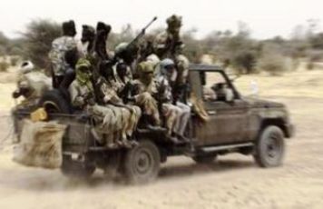 Fighters from the JEM ride in the back of a vehicle (file/Reuters)