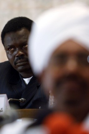 FILE - Sudanese President Omer Hassan al-Bashir's presidential assistant and leader of the Darfur rebel faction Minni Arcua Minnawi (L) listens to Bashir's speech during a rally organised by Bashir's supporterswho are against the arrest warrant for him issued by the International Criminal Court (ICC), in Khartoum March 17, 2009