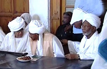 Farouk Abu Issa, chairman of the NCF opposition alliance (L), talks with NUP leader Sadiq al-Mahdi NUP leader (C), while Popular Congress Party leader Hassan Al-Turabi looks on (R) at a meeting held by the opposition leaders in Omdurman on 26 December 2010 (ST)