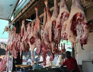 A butcher sells meat at a market in Sudan's capital Khartoum (Reuters)