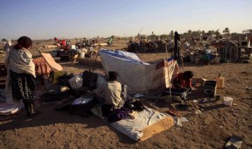 A family from southern Sudan, who has been staying in the north for 21 years, waits in Khartoum January 9, 2011 to be transported in a convoy back to the Abyei oil region (Reuters)