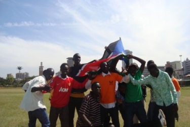 A group of young southern Sudanese holding the flag of their potential new state, Railway Club, Nairobi, Kenya, January 9, 2011 (ST)