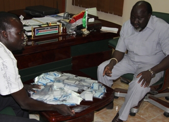 Governor Chol Tong Mayay seeing voter cards in his office in presence of his private secretary Mayen Maluaac Thursday Jan 6, 2011 (Photo by Manyang Mayom)
