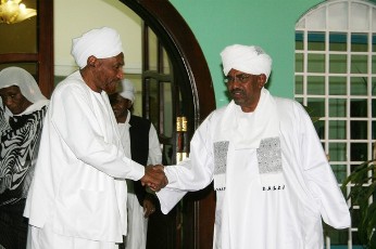 Sudan's President Omer Hassan Al-Bashir shakes hands with the leader of Umma Party and former prime minister Al-Sadiq Al-Mahdi in Khartoum January 22, 2011 (Reuters)