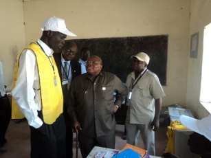Mkapa listening to a polling staff in Bor, Jan 10, 2011 (ST)