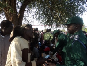 An elderly man asks a police officer if he can move to the front of the queue to vote on the first day of South Sudan's referendum. Jan 9, 2011 (ST)