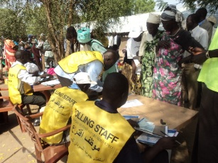 Polling staff checking people's name and issuuing out ballot papers at Nigel church in Bor, Jonglei State. Jan 10, 2011 (ST)