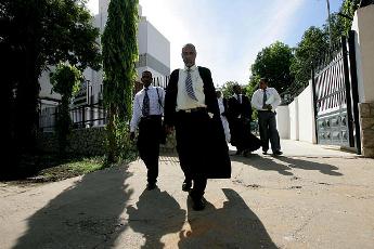 A group of lawyers walk out of the constitutional court after delivering papers as part of their legal bid to halt a referendum on southern Sudanese independence, in Khartoum on December 12, 2010 (AP)