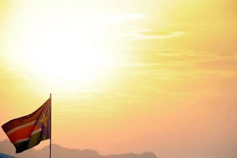 A Southern Sudanese flag flutters at sunset on January 15, 2011 (AFP)