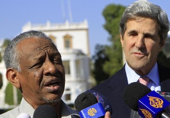 Presidential adviser Nafi Ali Nafi talks to reporters as U.S. Senator John Kerry (R) looks on after meeting at the presidential palace in Khartoum January 5, 2011 (Reuters)