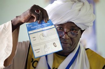 SSRC staff member shows the voting ballot during the official counting of votes on South Sudanese independence at the Armed Forces Club polling center in El Fasher, north Darfur January 15, 2011 (Reuters Pictures)