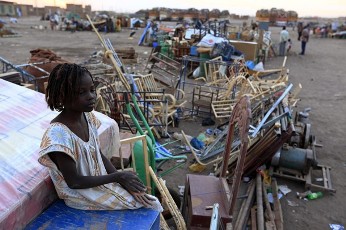 A girl from Wau, a town in southern Sudan, sits with her belongings as she waits for the Government of southern Sudan (GOSS) to transport her back before the secession referendum, in Mayo, 25 km (15 miles) south of Khartoum January 4, 2011 (Reuters)
