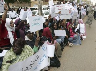 Dozens of Sudanese women protest Tuesday Aug. 4, 2009, outside a Khartoum court where a female journalist is on trial for wearing trousers in public -- a violation of the country's strict Islamic laws (AP Photos)