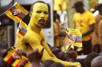 A supporter of Uganda's President Yoweri Museveni of the National Resistance Movement (NRM) Party, with his body painted yellow, attends the last presidential campaign rally in the capital Kampala, February 16, 2011. (Reuters)