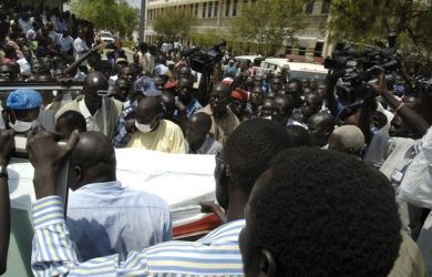 Civilians carry the body of a slain police officer to an ambulance after the killing of South Sudan's Minister for Rural Development and Cooperatives Jimmy Lemi at the ministry compound in Juba February 9, 2011.  (Reuters)