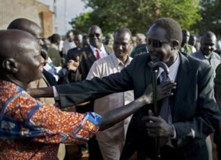 Gabriel Tanginye shakes hands with leading members of the Nuer tribal community in Unity state, Bentiu on October 19, 2010 (AP)