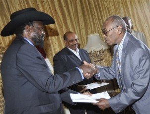 The head of the referendum office Mohamed Ibrahim Khalil, right, hands the final results of the referendum on Southern Sudan's independence to President of the semi-autonomous Government of Southern Sudan, and Vice President of Sudan Salva Kiir at the palace in Khartoum, Sudan, Monday, Feb.7, 2011 (AP)