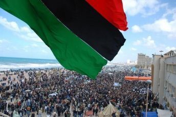 Protesters wave a flag in this undated picture made available on Facebook February 20, 2011. The image was purportedly taken recently in Benghazi. (Reuters)