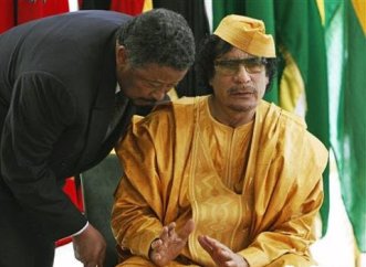 FILE - African Union Commission Chairperson Jean Ping (L) talks with Libyan leader Moammar Gadhafi ahead of 13th AU summit in Sirte, Libya (AP)