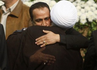 Hezbollah member Sami Chehab, who escaped from an Egyptian prison during the Cairo uprising, embraces Lebanon's Hezbollah deputy leader Sheikh Naim Kassem during a rally in Beirut's suburbs February 16, 2011 (Reuters)