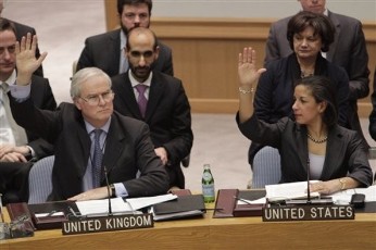 British Ambassador to the United Nations Mark Lyall Grant and American Ambassador Susan Rice vote during a Security Council vote on a resolution during a United Nations Security Council diplomat meeting on Libya at U.N. headquarters in New York February 26, 2011 (AP)