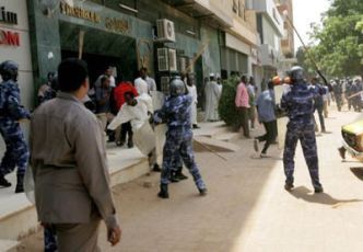 Members of Sudan’s anti-riot police beating anti-government demonstrators in Khartoum on 30 January