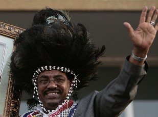 FILE - Sudan's President Omer Hassan Al-Bashir, wearing a southern traditional dress, attends a protest with southern Sudanese people against the International Criminal Court (ICC) arrest warrant for him, in Khartoum March 7, 2009 (Reuters)