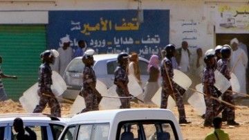 Sudanese riot police hold their shields and sticks as students clashed with police heeding calls to take to the streets for a day of nationwide, anti-government protests despite a heavy security deployment in the capital Khartoum, on January 30, 2011 (AFP)