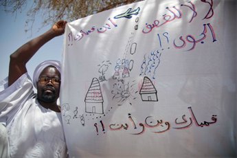 Villagers at the rebel controlled Fanga Suk, east Jebel Marra in west Darfur hold up banners saying 