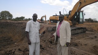 Rhino Star Manger, Bol Ajuong, (left) with Minister of Physical infrastructure, Manawe Peter Gatkuoth (right) testing the soil used by Rhino Stars Company at Carakou. March 18, 2011 (ST)