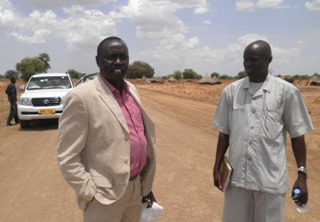 Jonglei state minister for infrastructure Peter Manawe (left) and Rhino Star Manager Bol Ajuong Kuol (right) standing on the new road at Carakou. March 18, 2011 (ST)