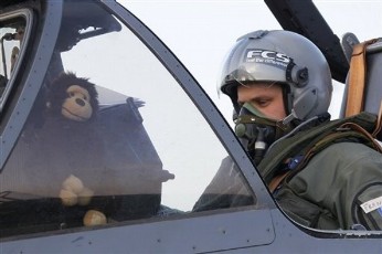 A French Air Force pilot of a Mirage 2000 jet fighter, with a monkey toy in his cockpit, prepares for a mission to Libya, at Solenzara 126 Air Base, on Corsica Island, Saturday, March 26, 2011 (AP)