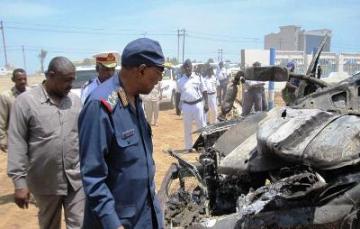 Sudanese defense minister Abdel-Rahim Mohamed Hussein inspecting wreckage of car that was destroyed in air strike April 9, 2011 (SMC)