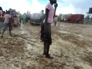 A girl gets her shoe stuck in tghe mud as she walks to attend the celebrations of the SPLA's 28th anniversary in Bor, the capital of Jonglei state in South Sudan. May 27, 2011 (ST)