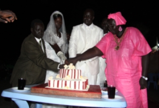 Benjamin Lok Jiet Abol (centre right) and Elizabeth Durciek Marial Makuac (centre left) cut their wedding cake in Rumbek twon of Lakes state, South Sudan. (ST)