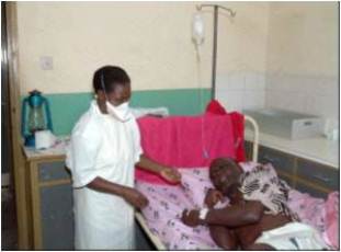 Nurse treats a man suspected of carrying the Sudan strain of Ebola, Uganda (AFP)