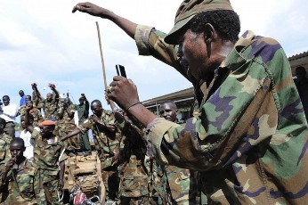 Personnel from the northern army's Sudanese Armed Forces (SAF) component of the Joint Integrated Units (JIU) celebrate on the barge as they prepare to leave for northern Sudan, in Juba in this picture taken April 7, 2011 and released by UNMIS April 12, 2011 (Reuters)