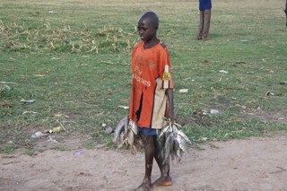 Yirol West finsher boy walking to sell fish in Yirol market. Lakes state, South Sudan. April 29, 2011 (ST)