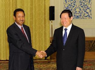 Zhou Yongkang (R), a member of the Standing Committee of the Political Bureau of the Communist Party of China (CPC) Central Committee, meets with Sudanese President Omaer Hassan al-Bashir's adviser Mustafa Osman Ismail in Beijing, capital of China, April 29, 2011. (Xinhua/Ma Zhancheng)