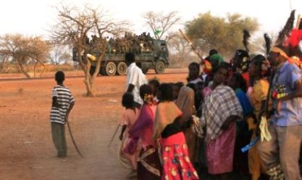 A military truck passes by as members of the Kenana Arab tribe perform a traditional dance after ballot boxes were sealed on the last day of voting, at Galayat locality in South Kordofan State May 4, 2011.  (Reuters)