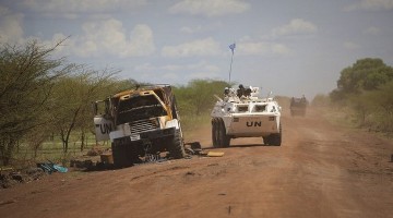 A patrol from the international peacekeeping operation passes a destroyed UN truck that was part of a convoy transporting northern soldiers out of the Abyei area in the Todach area, north of Abyei town, in this handout picture released by the United Nations Mission in Sudan (UNMIS) May 30, 2011