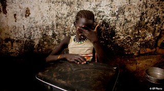 Atong Aken, age 9, weeps while clutching a suitcase in a makeshift internally displaced persons camps in Mayan Abun,southern Sudan on Thursday May 26, 2011. (AP)