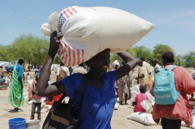 An internally displaced woman from Abyei carries food aid in Turalei May 27, 2011. (Reuters)