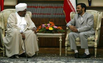 FILE - Iran's President Mahmoud Ahmadinejad (R) and Sudanese President Omer Hassan al-Bashir talk during an official departure ceremony for the Sudanese president in Tehran, Iran, April 26, 2006.(UPI)