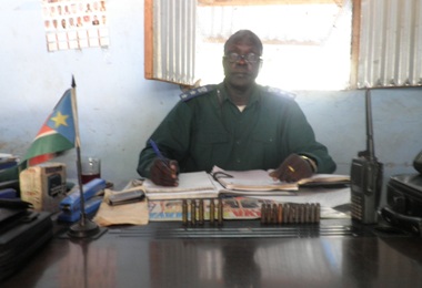 Bor County police Commissioner, Mabior Ruar, at his office in Bor with cartridges collected from the area attacked in front of him (by John Actually  ST)