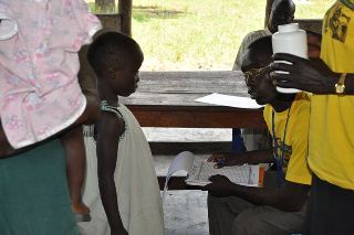 Health official attends to a child during the mass drug treatment conducted in Yei County, Central Equaotoria state, June 15, 2011 (ST)