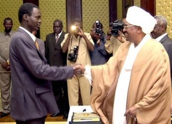 Minni Minawi shakes hands with Sudanese President Omar al-Bashir, Monday, Aug. 7, 2006, in Khartoum, after being appointed senior presidential Assistant. (AP)
