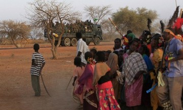 A military truck passes by as members of the Kenana Arab tribe perform a traditional dance after ballot boxes were sealed on the last day of voting, at Galayat locality in South Kordofan State May 4, 2011 (Reuters)