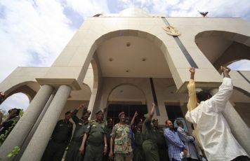 Military officers wave to supporters at the defence ministry a during a rally to voice support for the northern army, in Khartoum May 26, 2011 (REUTERS PICTURES)