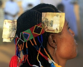 A member of the Kenana Arab tribe, with Sudanese pounds attached to her head gear, takes part in a tribal dance performance after ballot boxes were sealed on the last day of voting, at Galayat locality in South Kordofan State May 4, 2011 (Reuters)